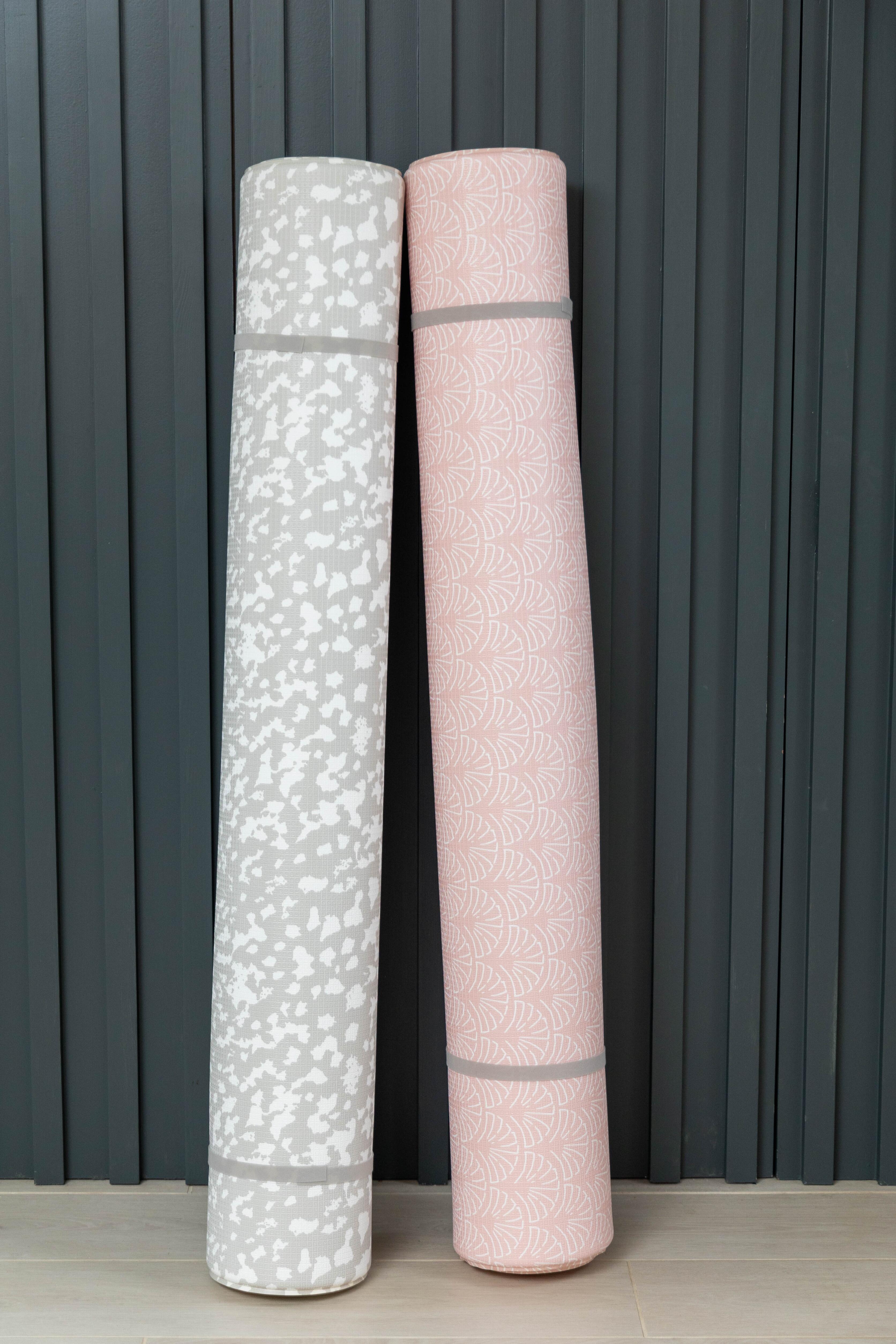 Large Speckled Kisses and Luxury Greige reversible playmats rolled together β non-toxic cushioned baby mats by Little Fae
