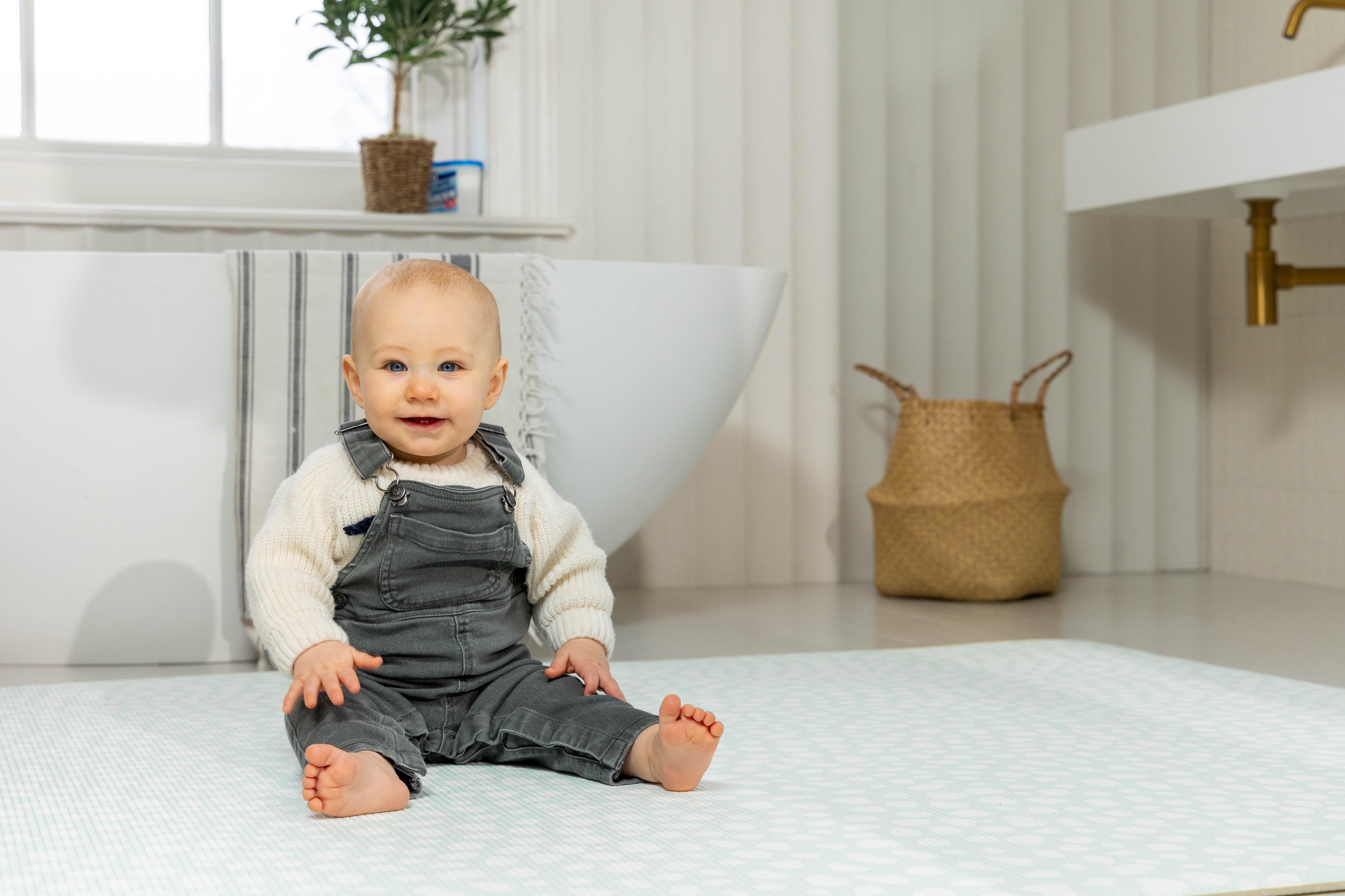 Baby playing on Soft Mint Darling Dalmatian Playmat – luxury non-toxic reversible baby mat for calm neutral nurseries