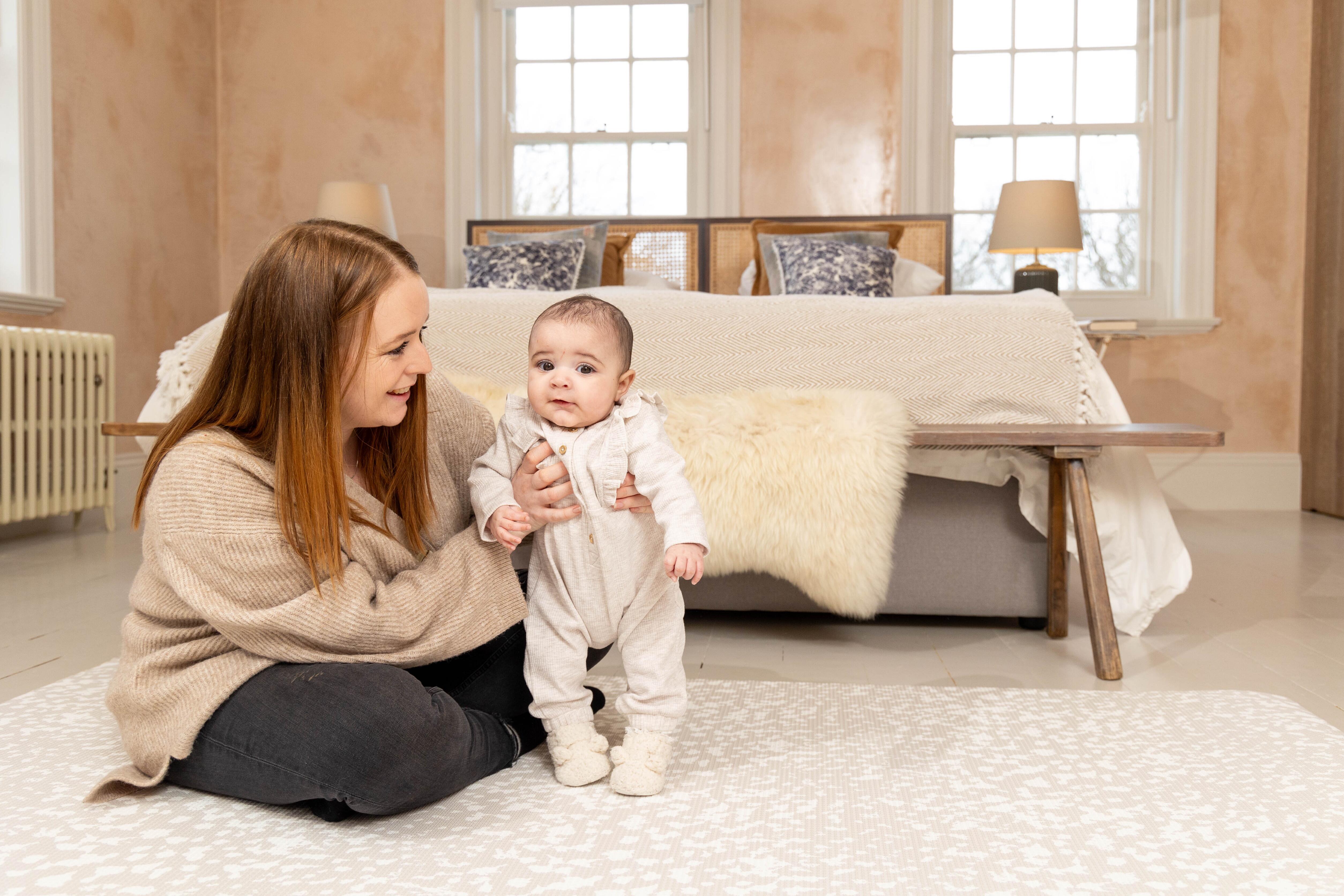 Speckled Kisses Playmat in Luxury Greige rolled neatly for simple storage