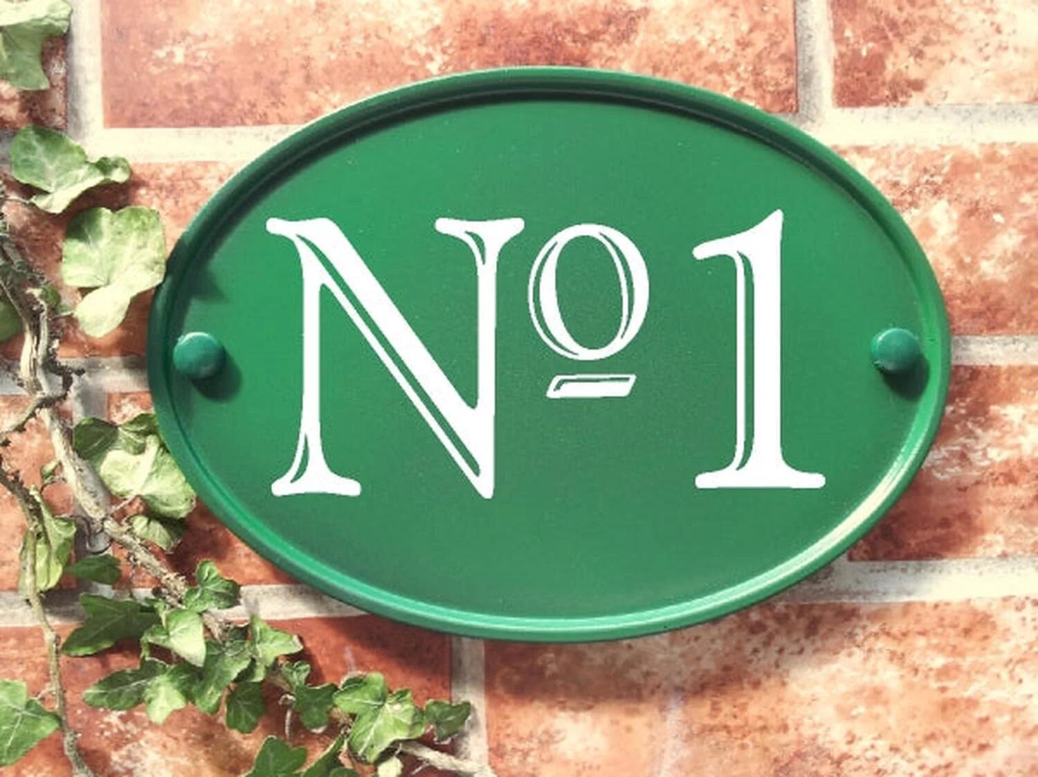 Green oval house number sign displaying No 1
