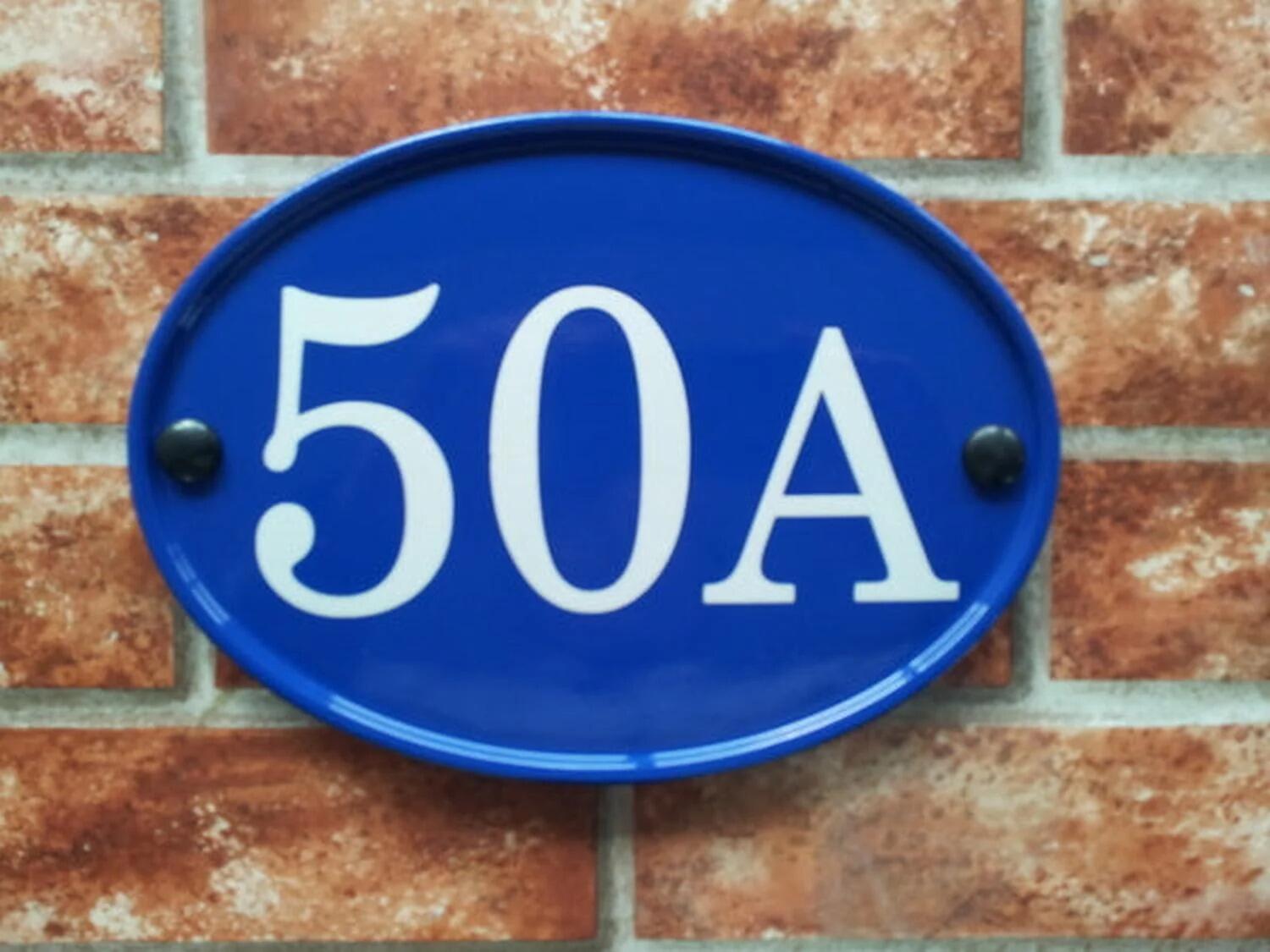 Blue oval house number sign displaying 50A