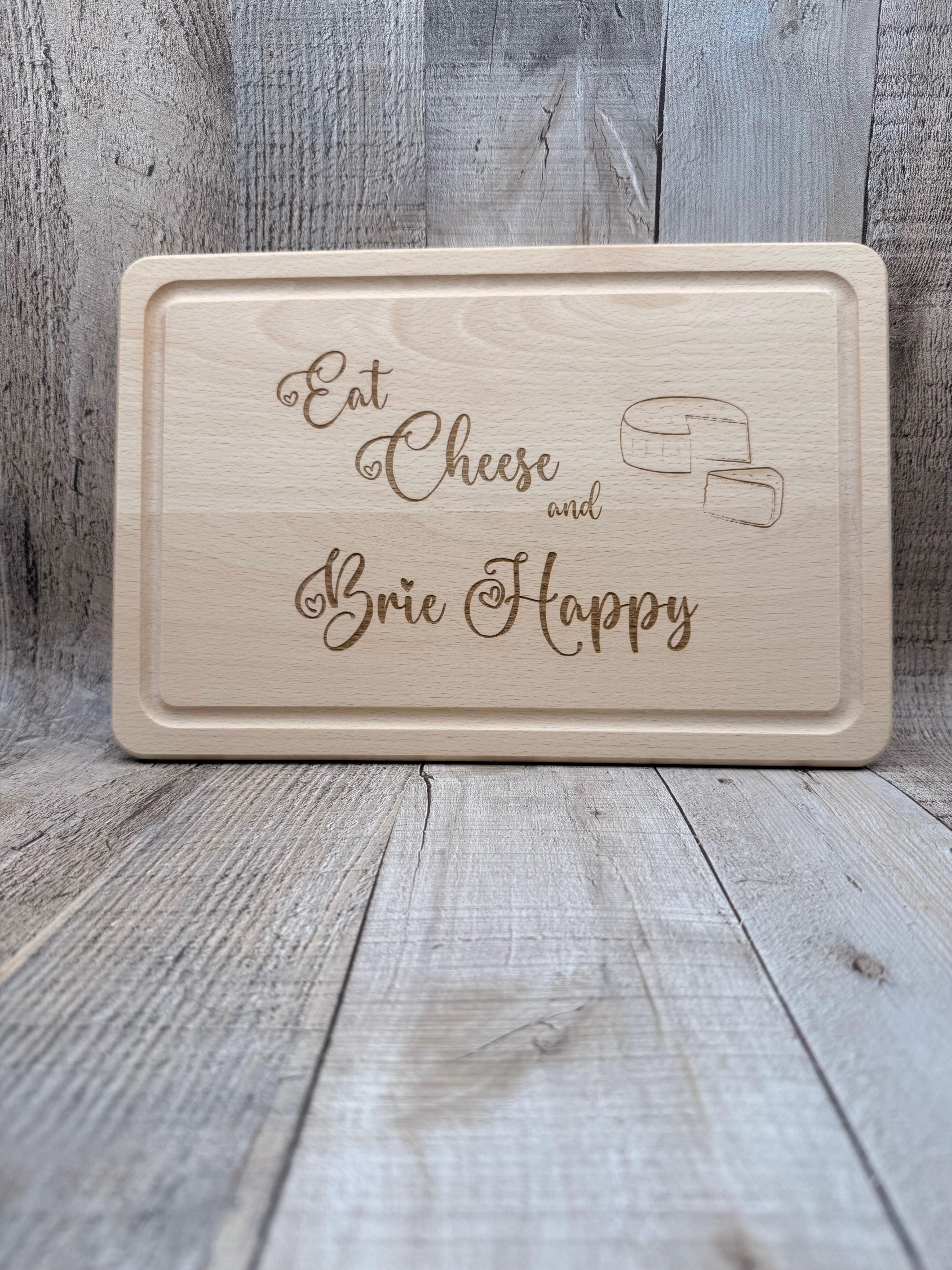 LASER ENGRAVED BEECH CHOPPING BOARD - EAT CHEESE AND BRIE HAPPY