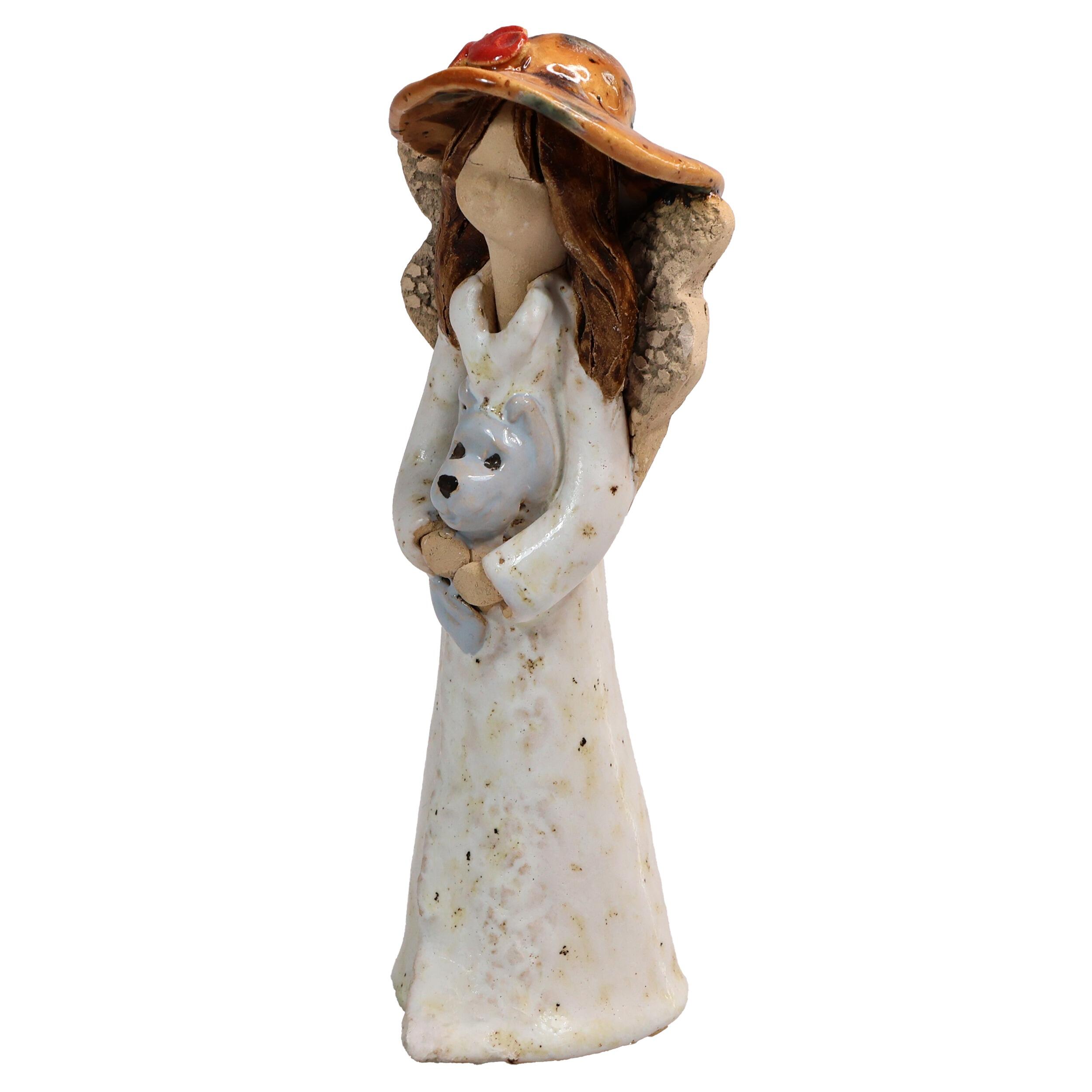 Handmade ceramic angel in white dress holding a grey dog, gift-packed. Unique ornament celebrating “The dog makes a house a home.”