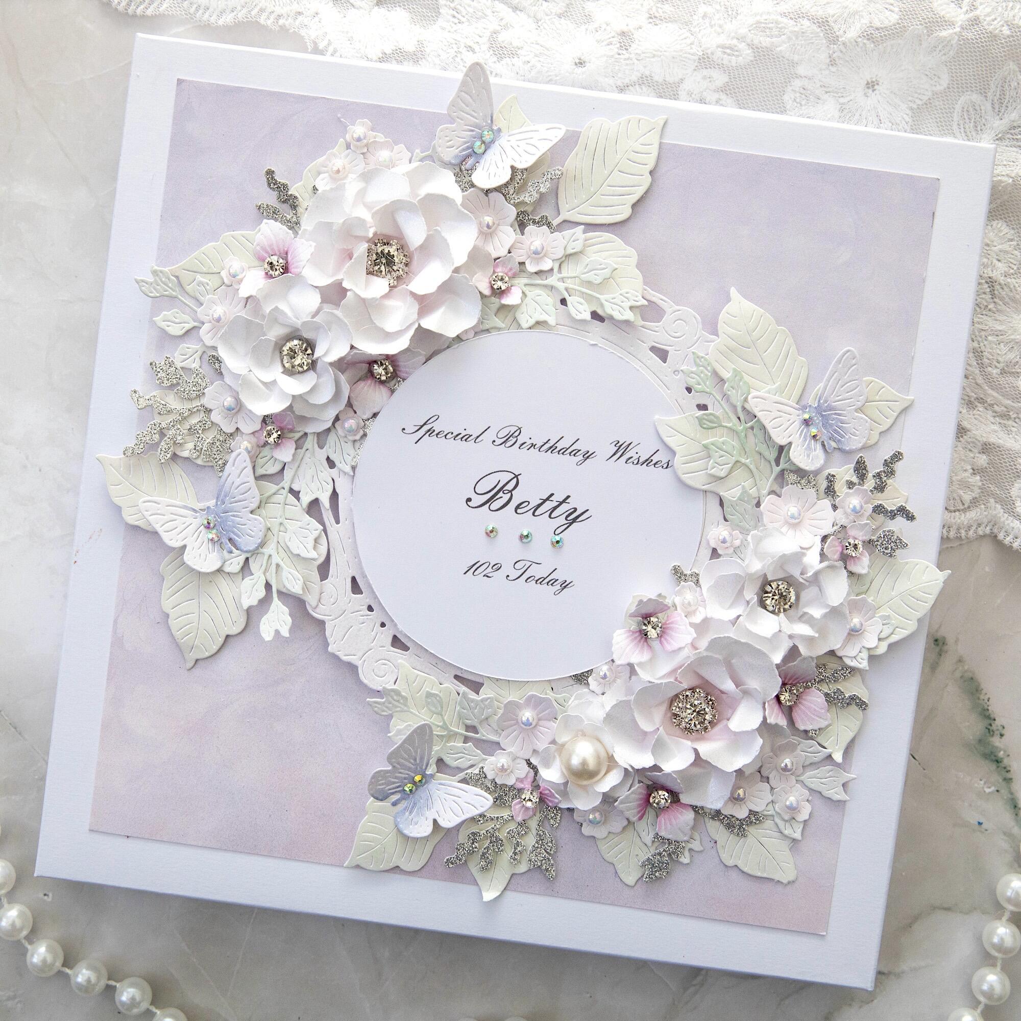 Luxury handmade 102nd birthday card for Betty made in Leicestershire with white 3D flowers, lilac butterflies, pearls, personalised for grandma, gift boxed