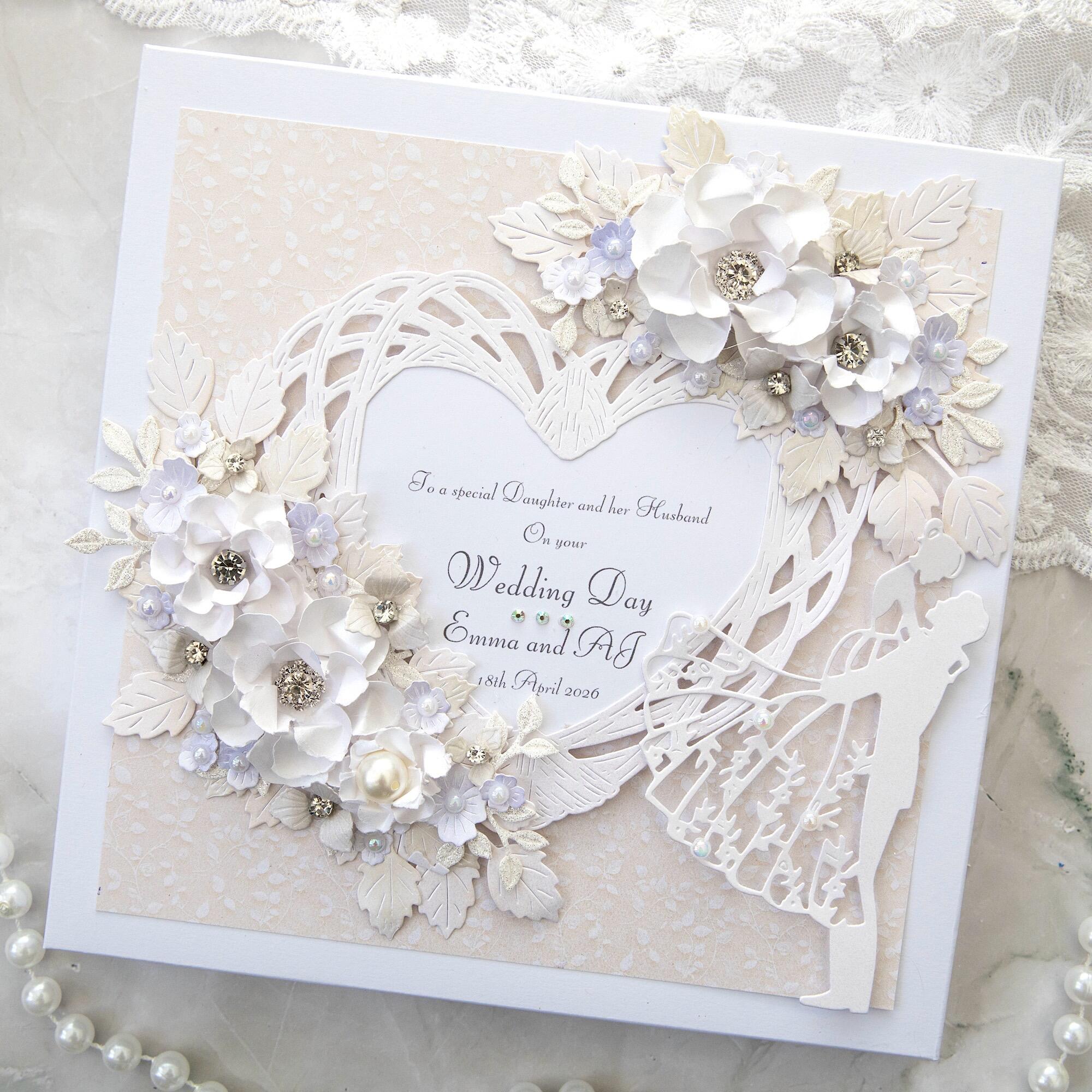 Handmade wedding card for daughter with ivory woven heart frame, white 3D flowers, lilac accents, pearl details and bride groom silhouette in gift box