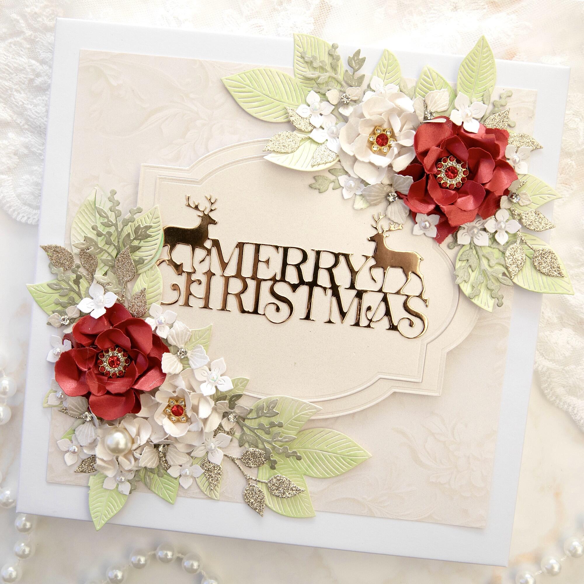 Luxury handmade personalised 8x8 Christmas card with gold mirrored Merry Christmas reindeer sentiment, red satin flowers with red crystal centres, white flowers, green leaves and gold glitter foliage, handmade in Leicestershire