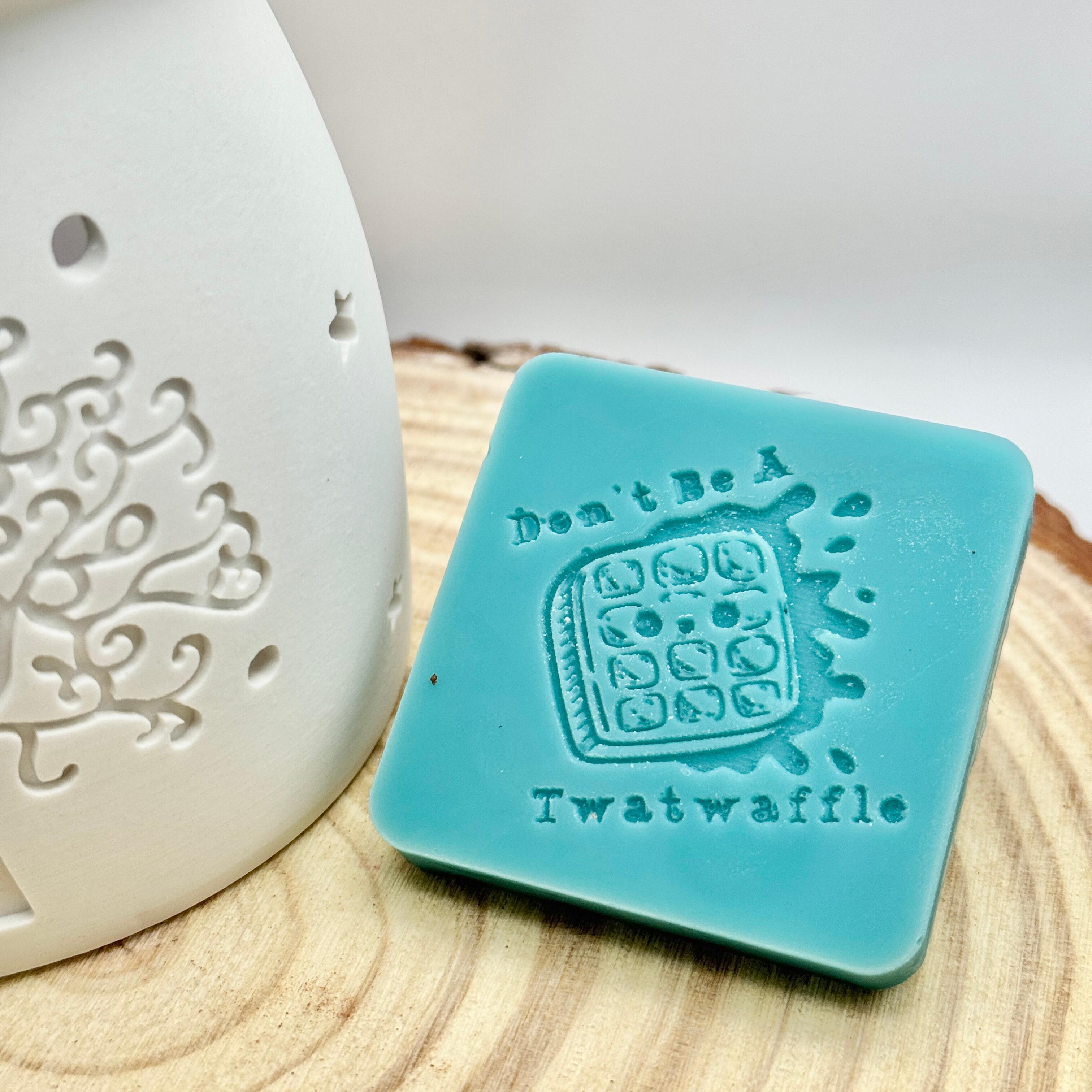 an image of a sweary wax melt square that reads twatwaffle
