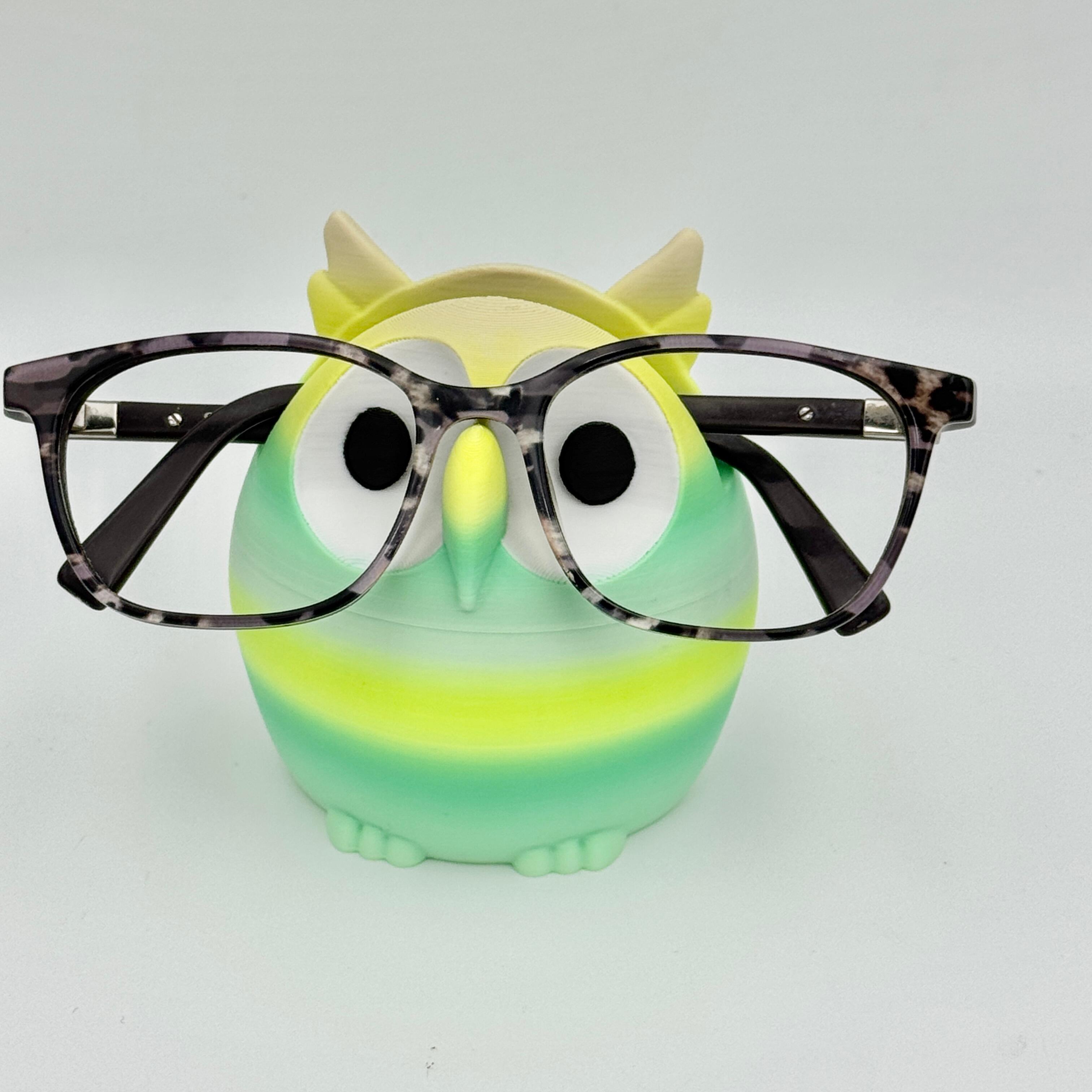 green and yellow owl shaped glasses stand