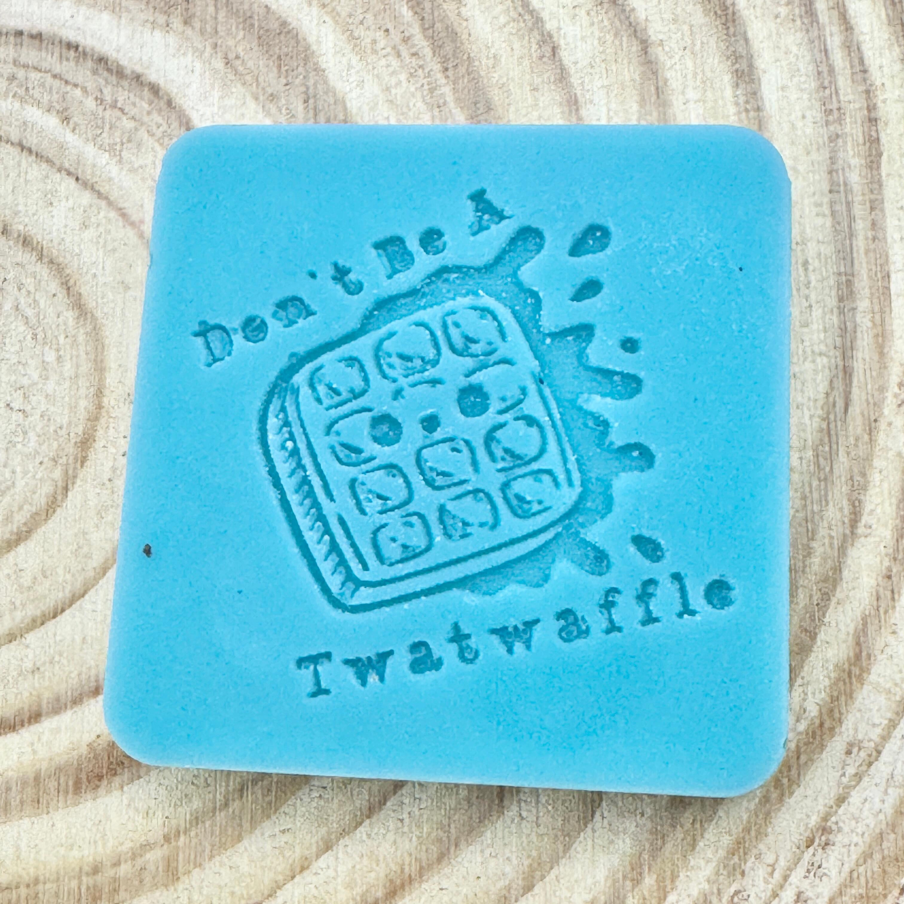 an image of a sweary wax melt square that reads twatwaffle