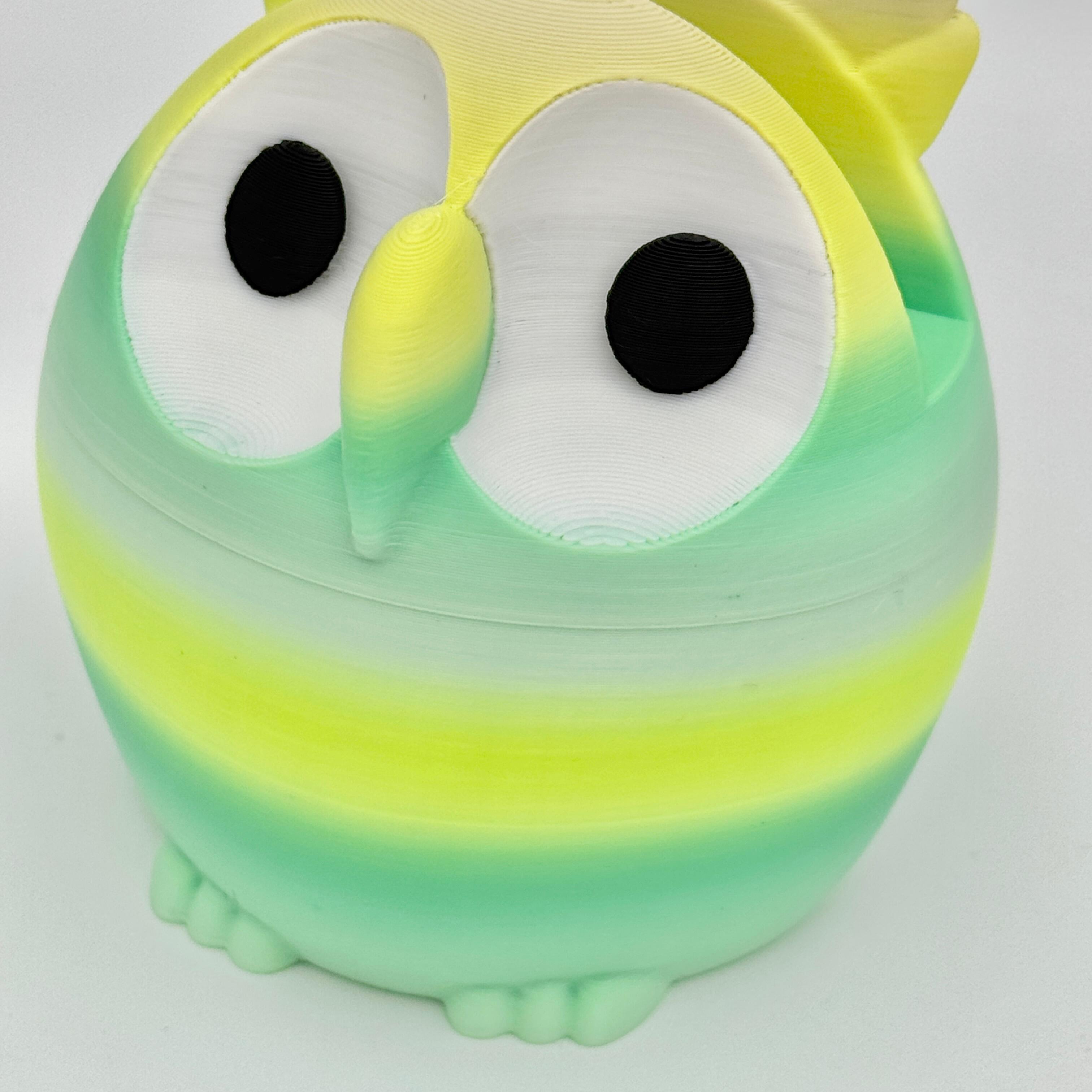 imperfection on green and yellow owl shaped glasses stand