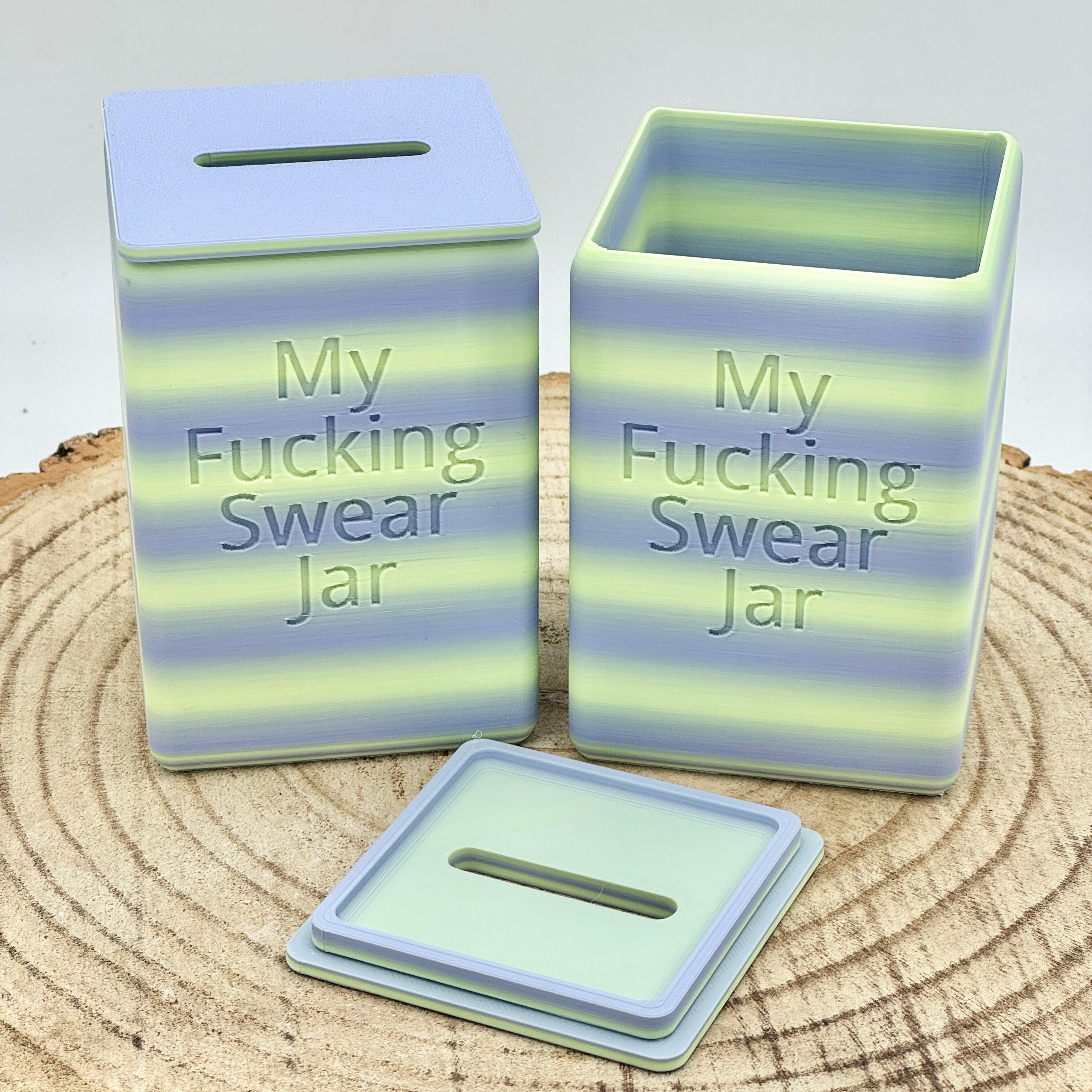 an image of the swear jar money box in sea grass, a combination of light blue and green