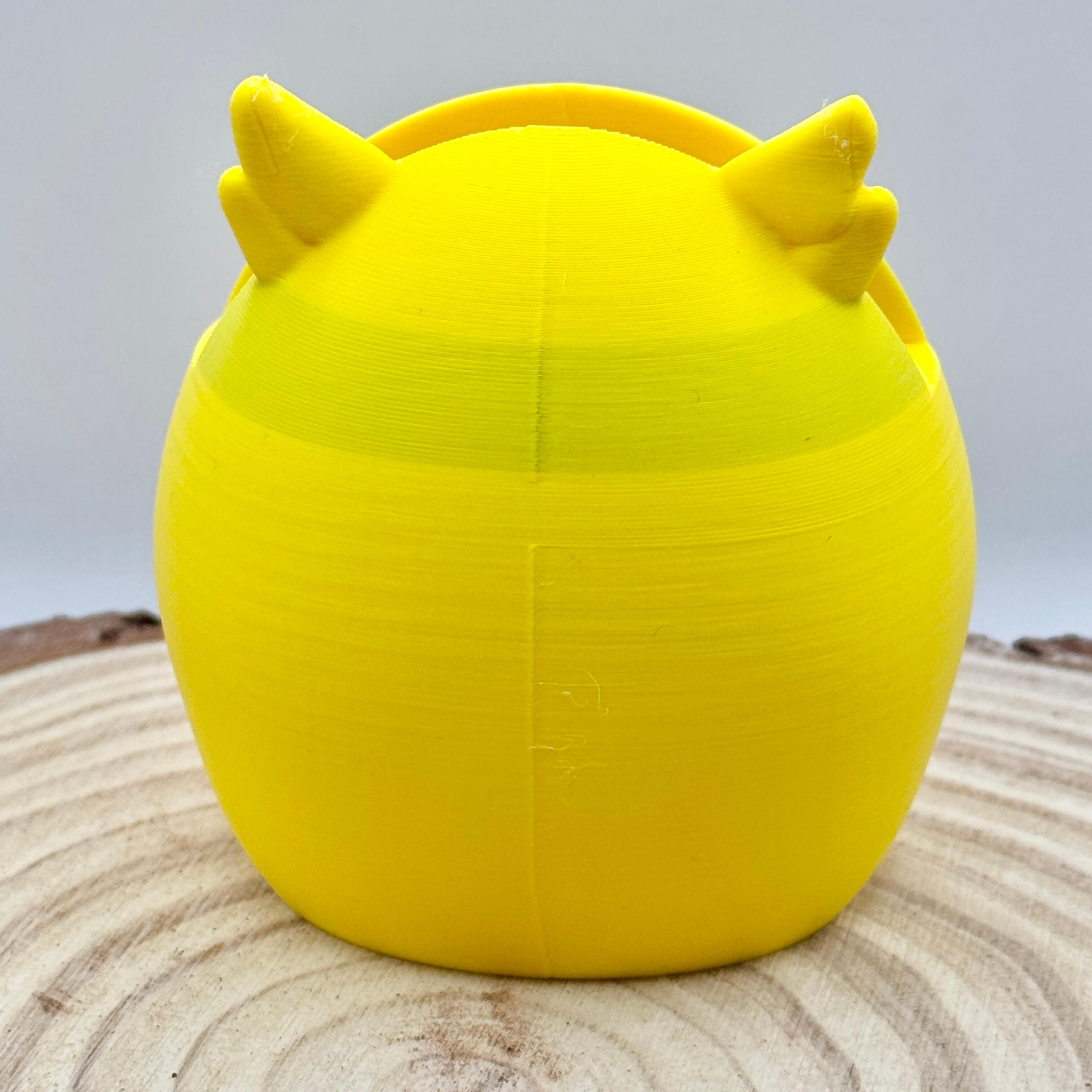 imperfection on yellow owl shaped glasses stand