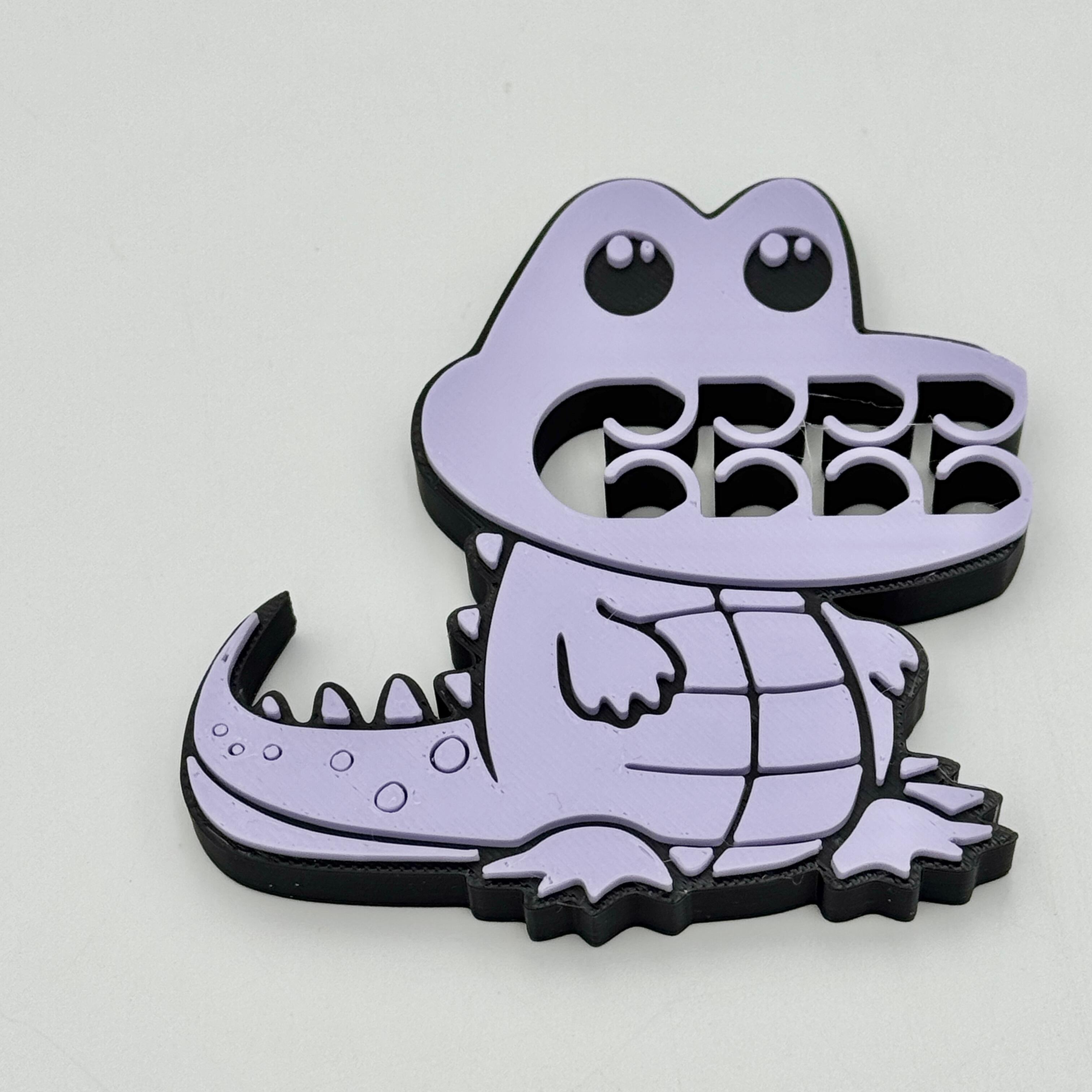 A lilac and black crocodile bag clip