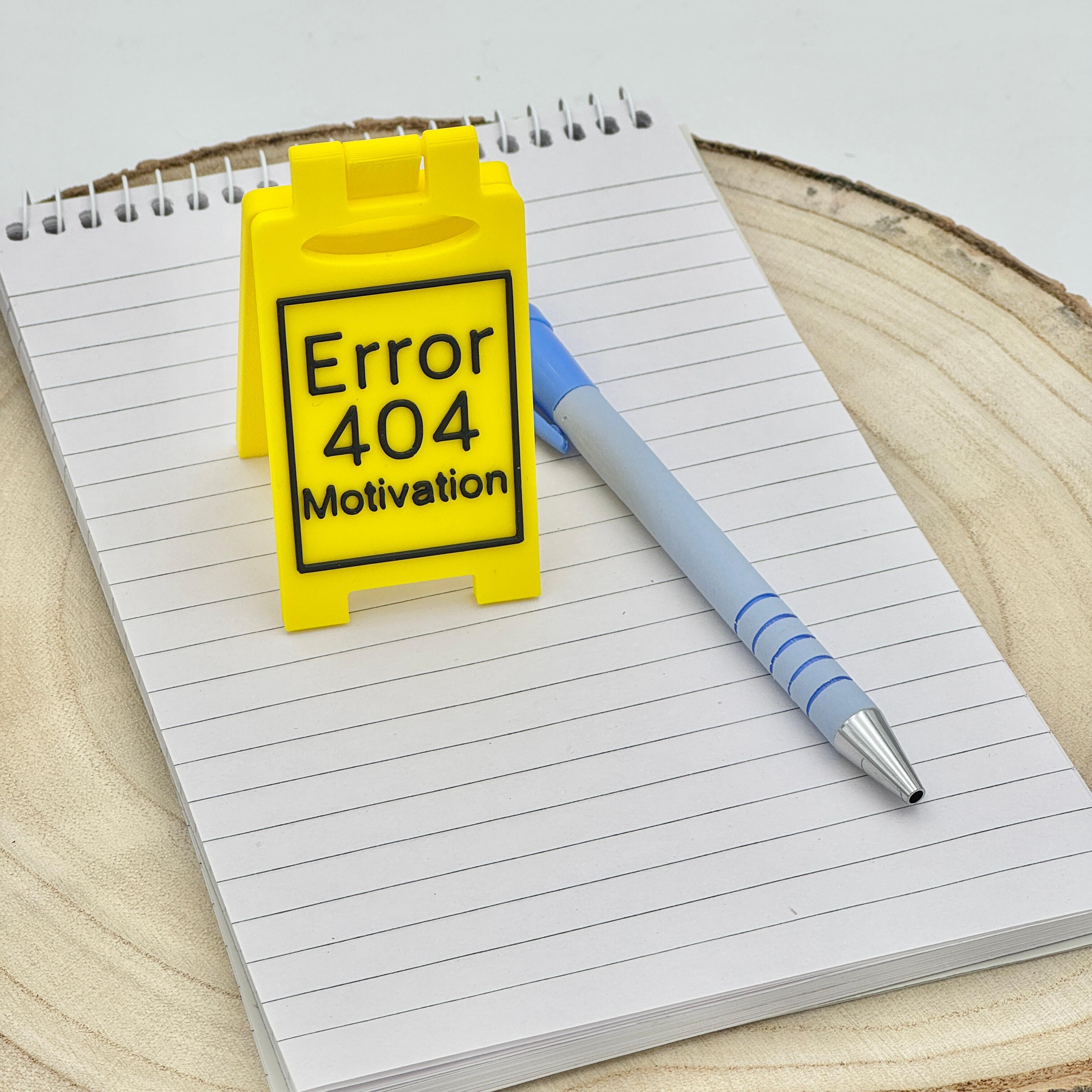 novely desk sign that reads error 404, motivation
