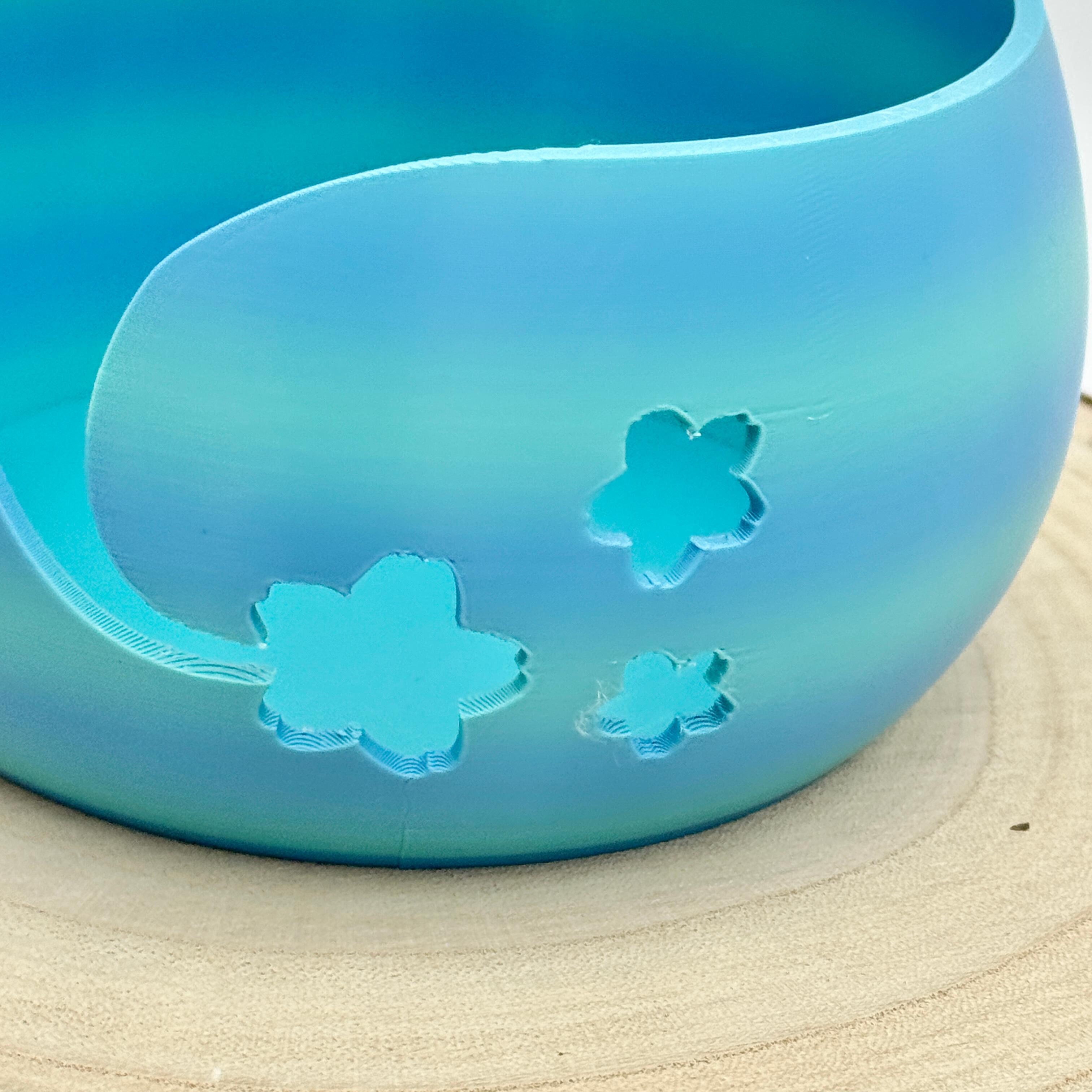 a close up image of a floral themed yarn bowl in shades of blue