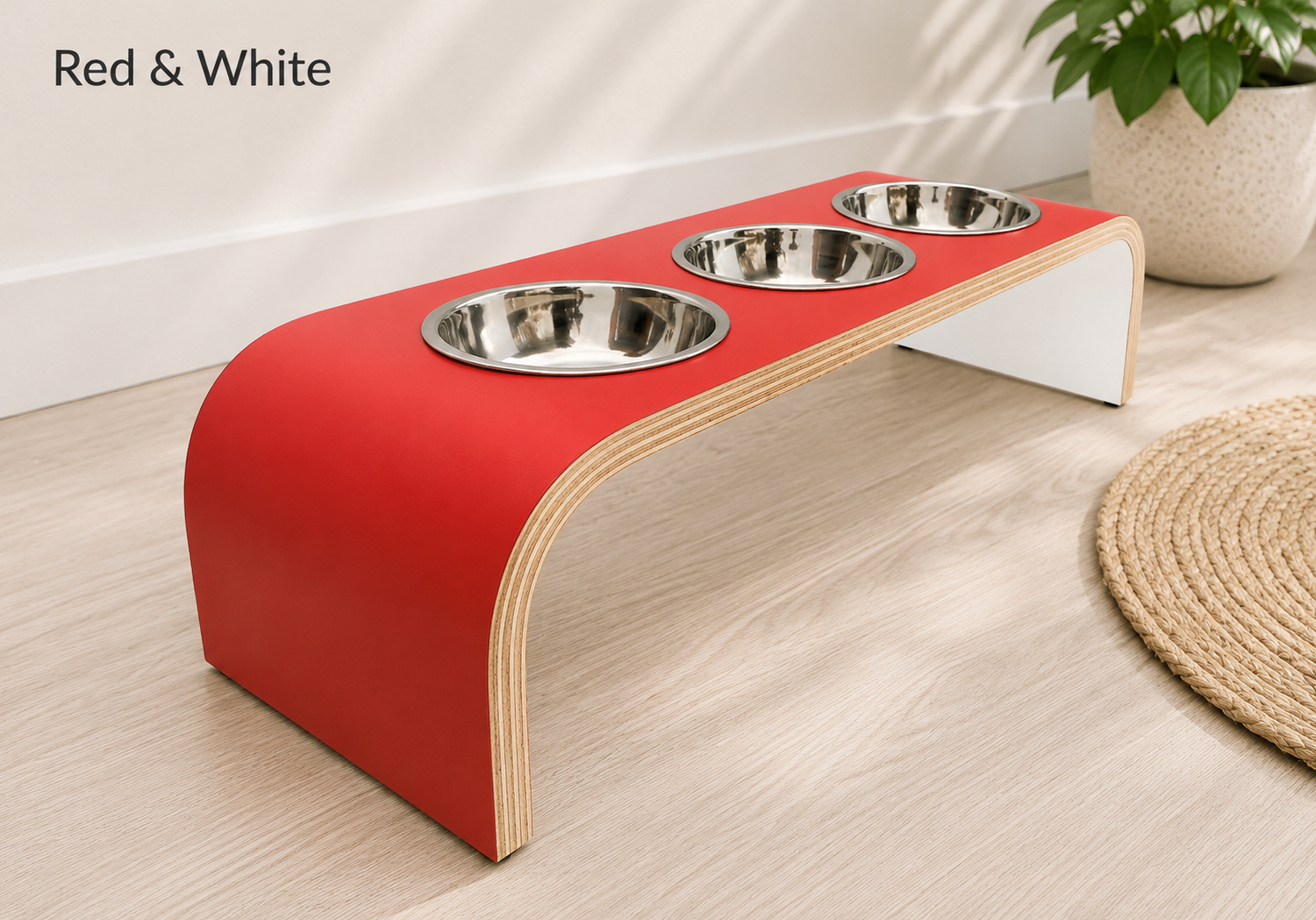 Modern red and white raised triple dog bowl stand with stainless steel bowls, handcrafted curved wooden pet feeder for dogs and cats.