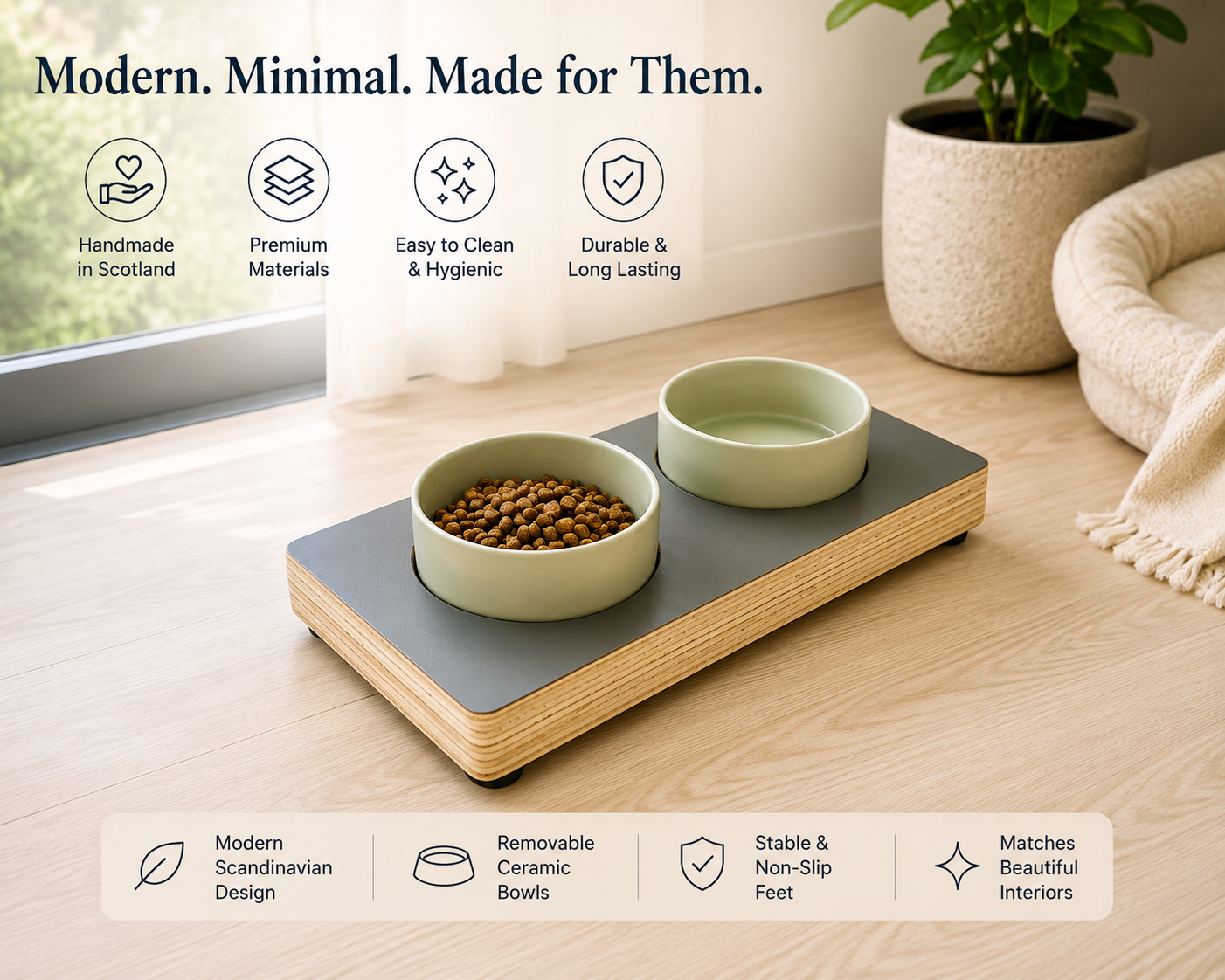 Handmade raised wooden pet feeder with two ceramic bowls in charcoal grey, modern minimalist feeding station for cats and small dogs displayed in a bright contemporary home.