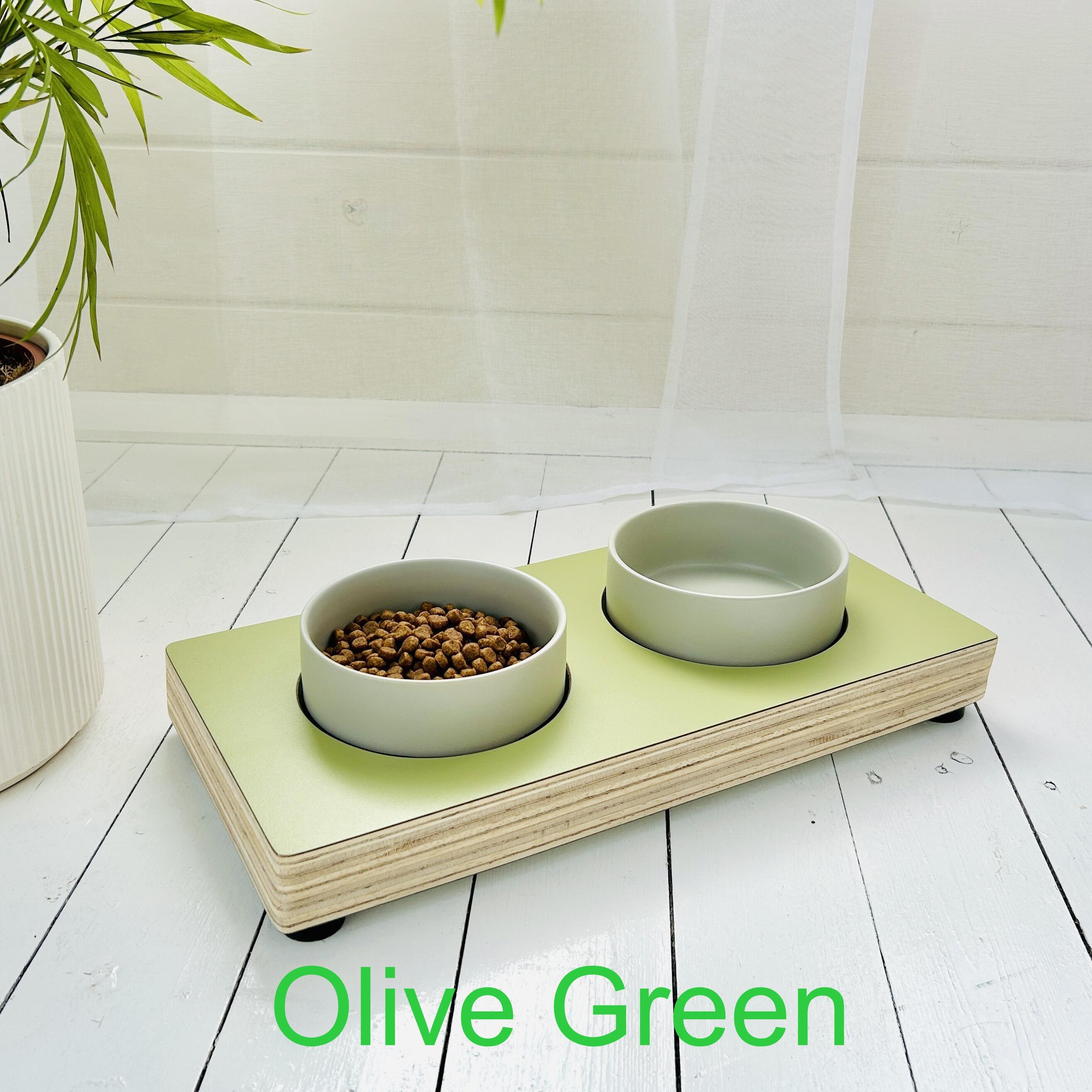 olive green wooden pet stand on white painted floor boards