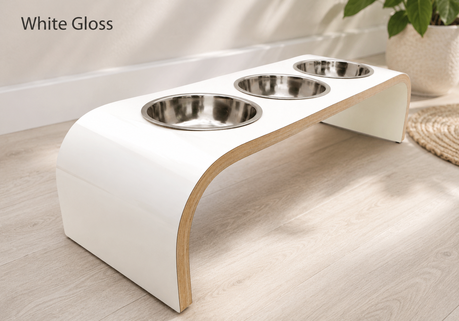 Modern white gloss raised triple dog bowl stand with stainless steel bowls, handcrafted curved wooden pet feeder for dogs and cats.