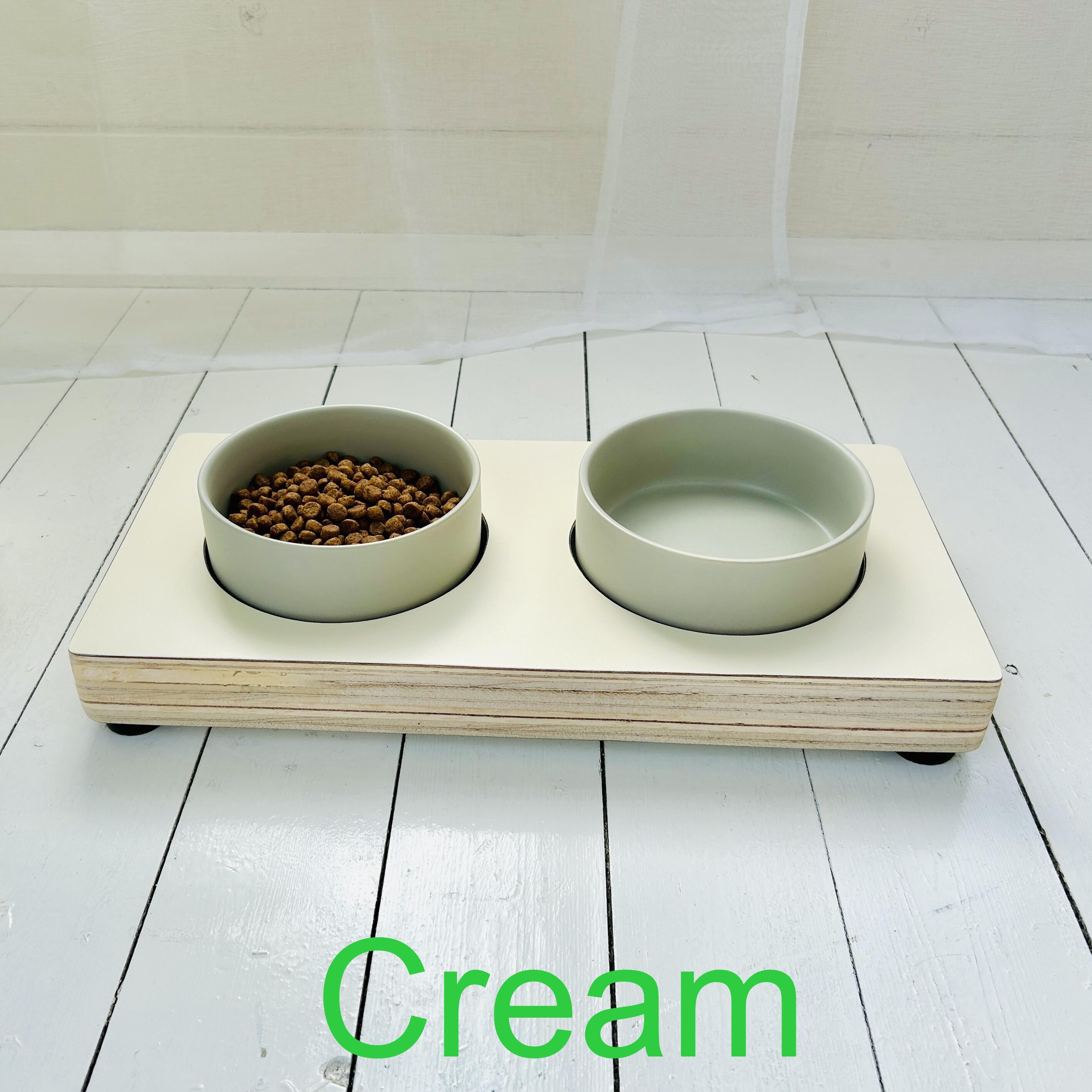 above view of cream coloured wooden dog feeder with grey ceramic bowls