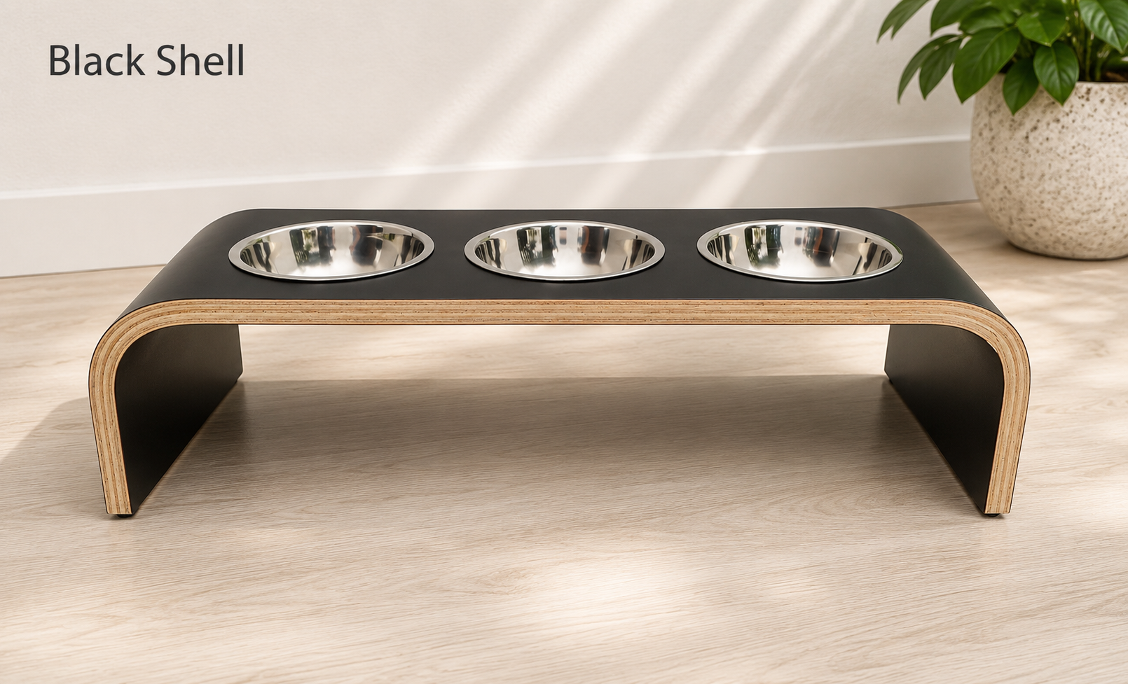 Modern black raised triple dog bowl stand with stainless steel bowls, handcrafted curved wooden pet feeder for dogs and cats.