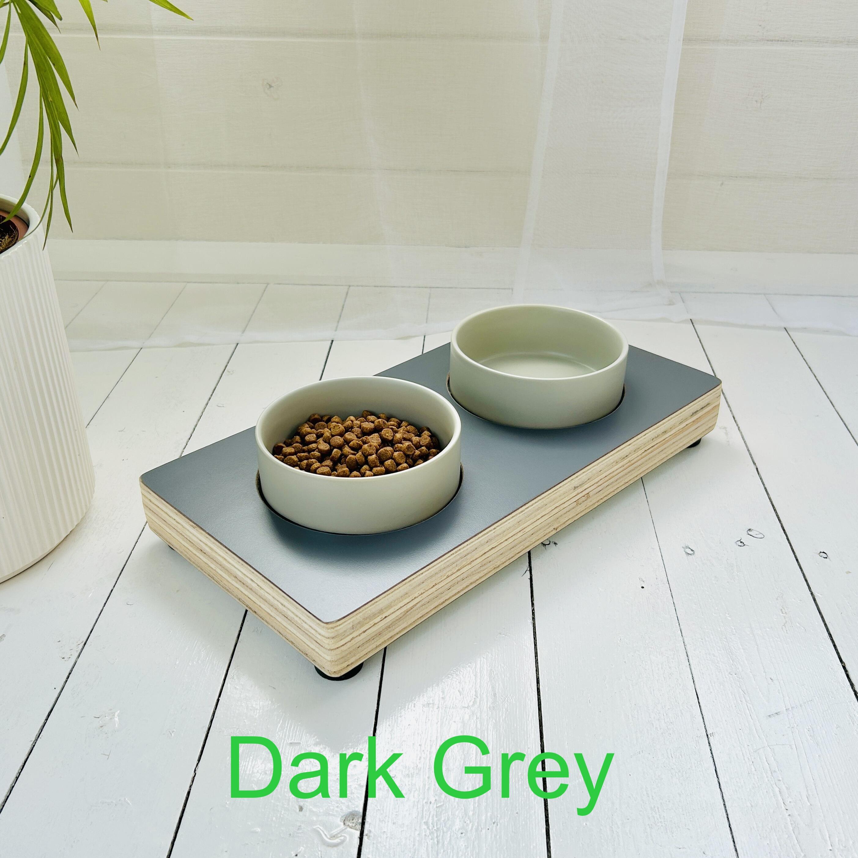 grey wooden pet feeder on white painted floor and wooden edge