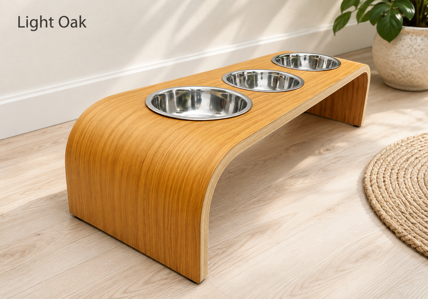 Modern light oak raised triple dog bowl stand with stainless steel bowls, handcrafted curved wooden pet feeder for dogs and cats.