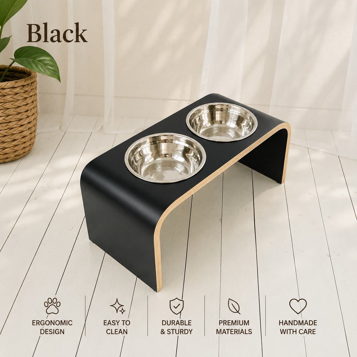 Handmade black raised dog bowl stand with two stainless steel bowls, modern elevated wooden pet feeder in a bright contemporary home, ergonomic feeding station for dogs and cats.