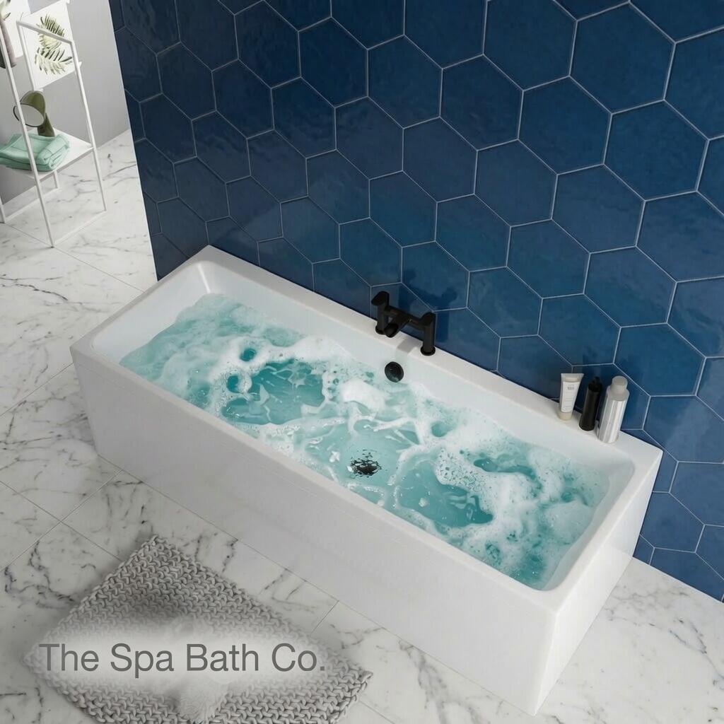 Serene modern bathroom with a whirlpool bath glowing in soft, layered chromotherapy colours — deep blue transitioning to calming green and warm violet — steam rising gently