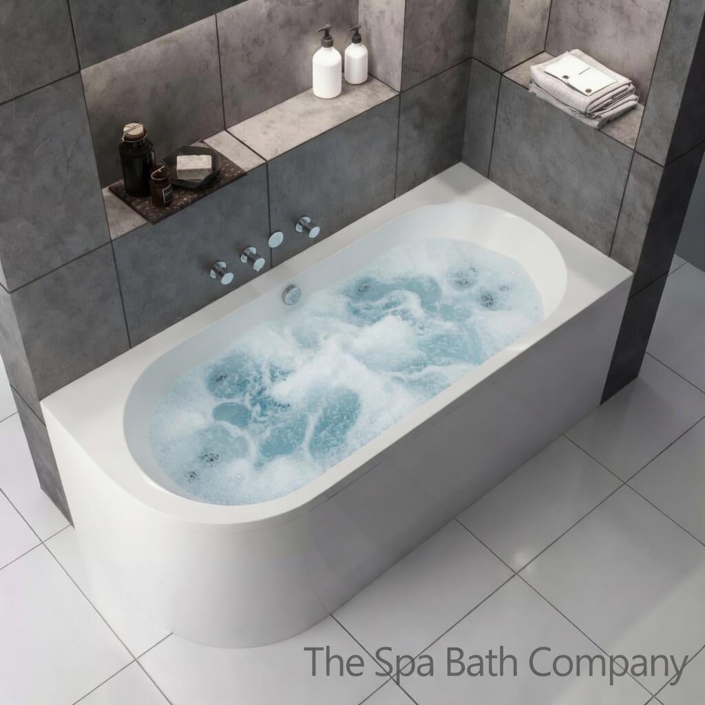 Luxury J shaped whirlpool bath filled with bubbling water