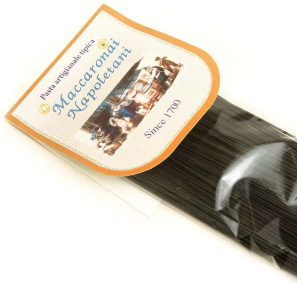 Black squid ink spaghetti pasta strands in packaging