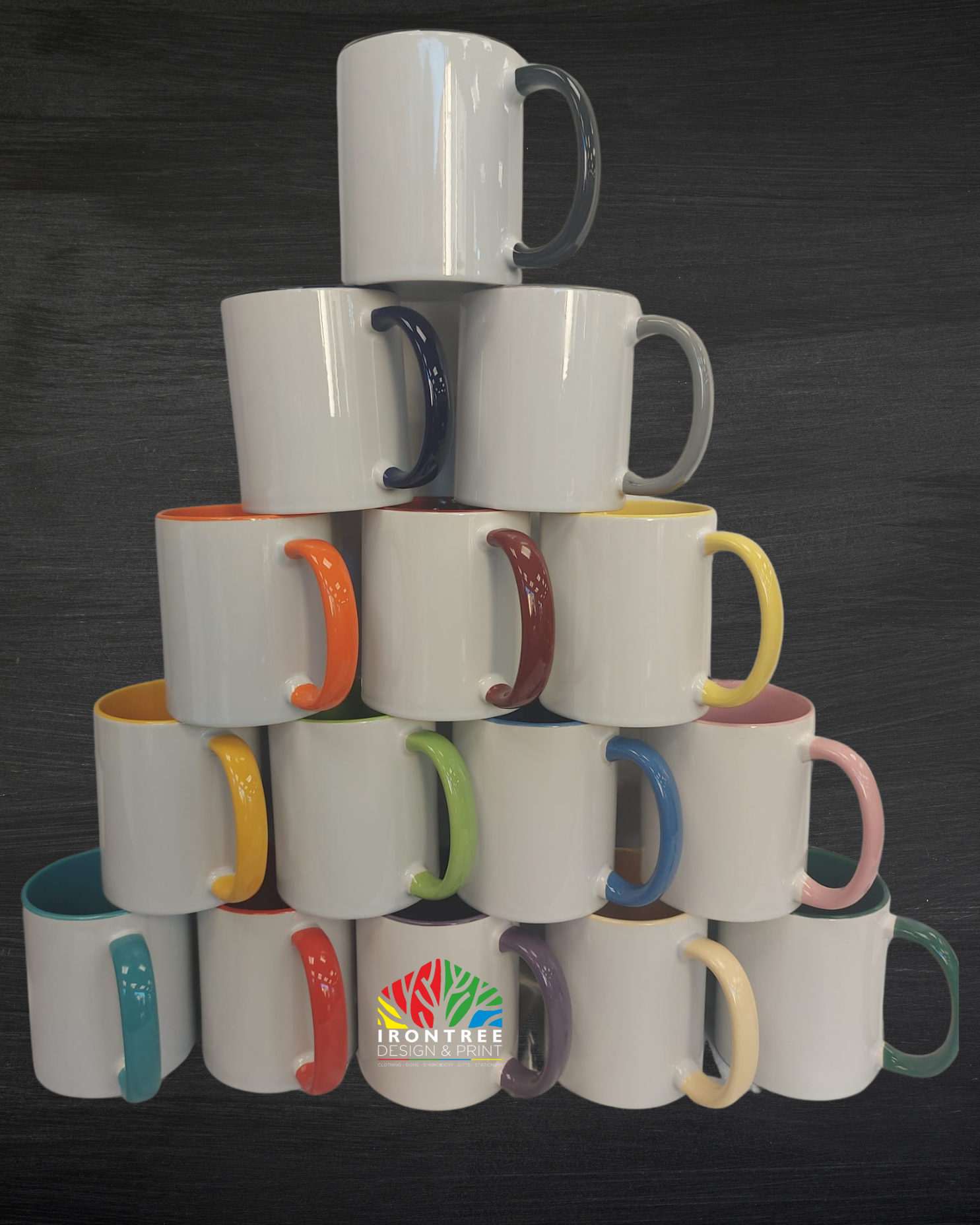STACK OF COLOURED MUGS