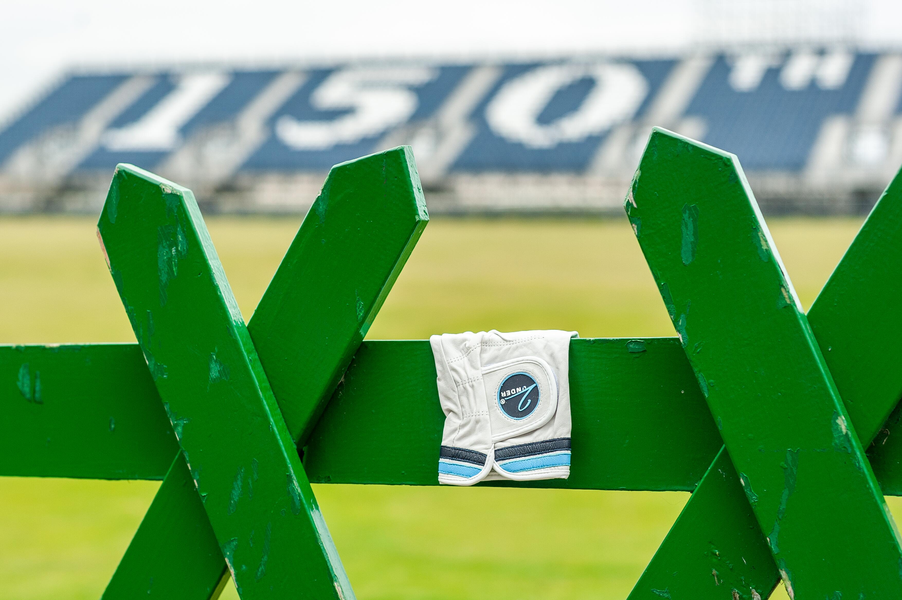 2Under Golf 'Links Sky' Premium Cabretta Leather Glove, in front of The 150th Open stands in St Andrews