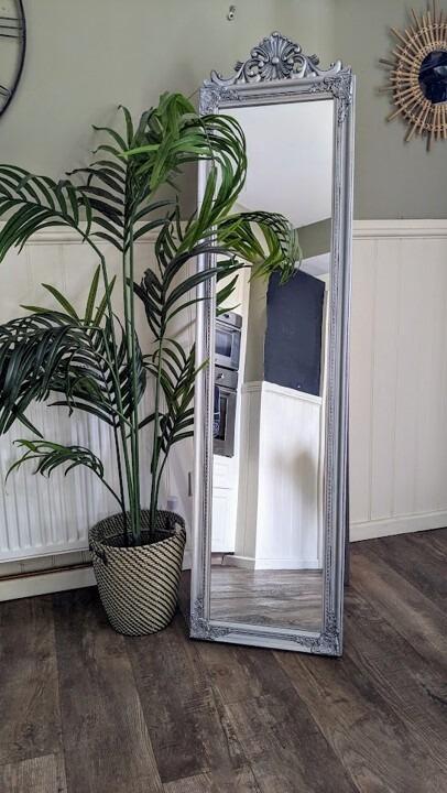 An image of a freestanding silver mirror