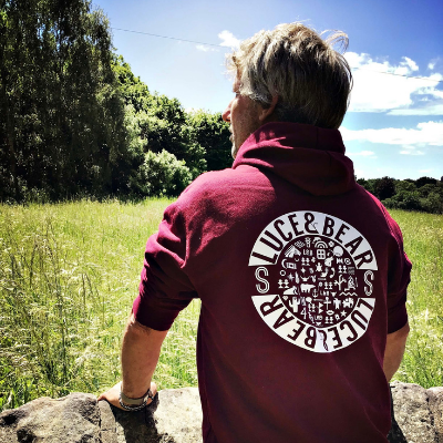 Man wearing burgundy Got Yer Back hoodie from the Menswear range