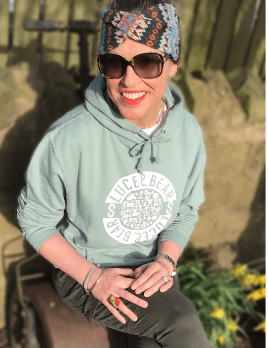 Woman wearing dusty green hoodie