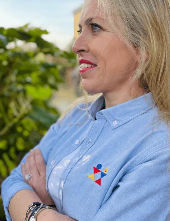 Woman wearing pale blue logo shirt
