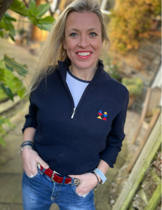 Woman wearing navy Re-gen 1/4 zip