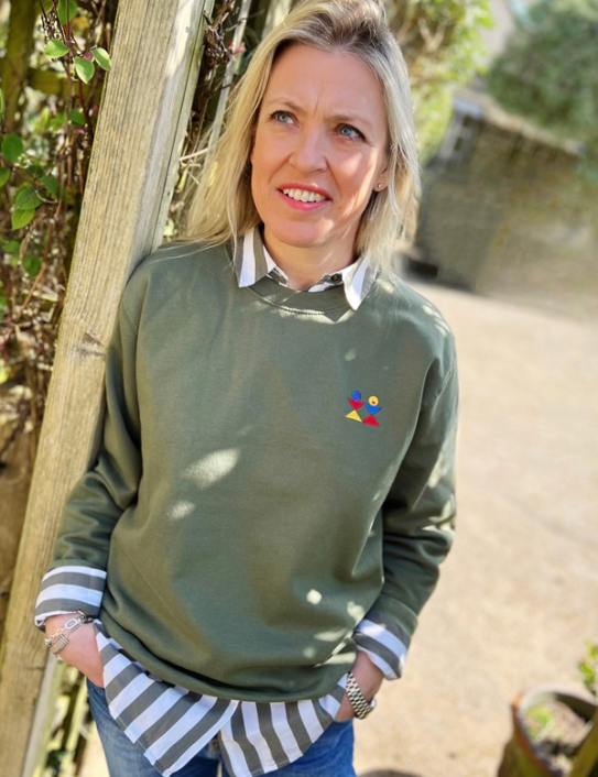 Woman wearing earthy green logo sweat