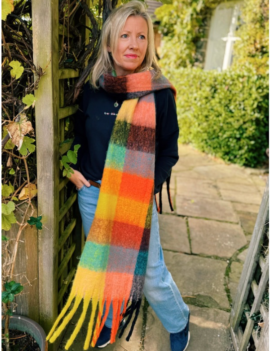 Woman wearing the Ultimate Blanket Scarf in Rainbow Brights