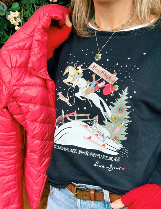 Woman wearing Riding Home for Christmas Sweatshirt