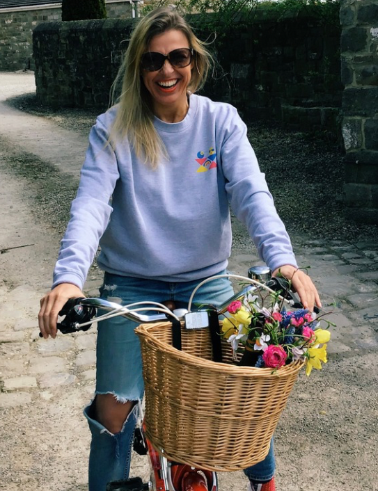 Woman wearing Rainbow Logo Sweatshirt in grey