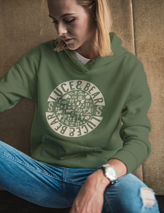 Woman wearing Unisex Healing Hoodie in earthy green