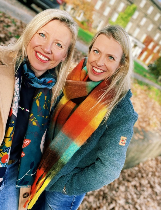 Woman wearing the Ultimate Blanket Scarf in Rainbow Brights