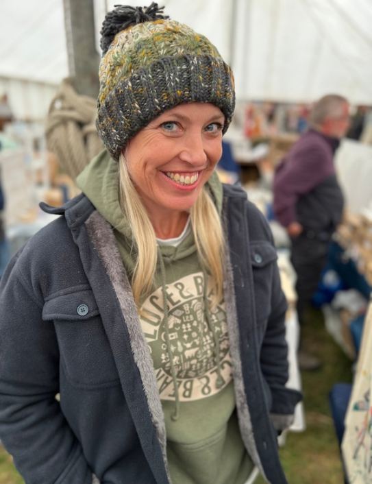Woman wearing Unisex Healing Hoodie in earthy green