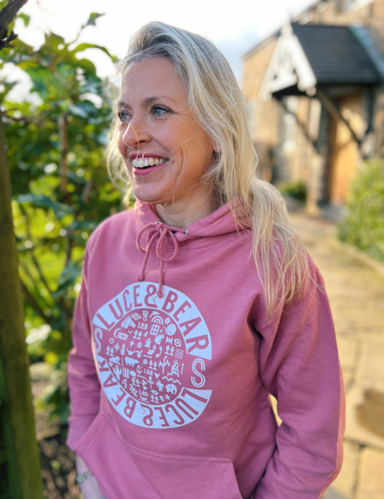 Woman wearing Unisex Healing Hoodie in rose