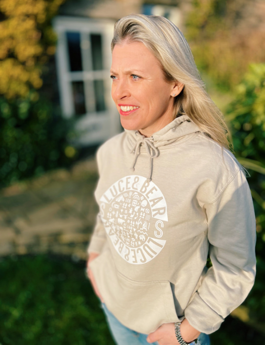 Woman wearing Unisex Healing Hoodie in stone