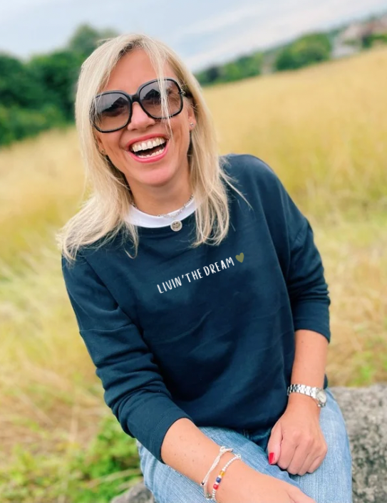 Woman wearing Livin the Dream Sweatshirt in navy