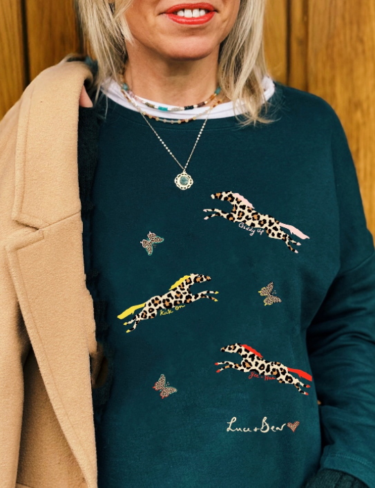 Woman wearing Fire Horse Sweatshirt in dark green