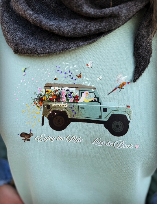 Close up of dusty green Enjoy the Ride sweatshirt